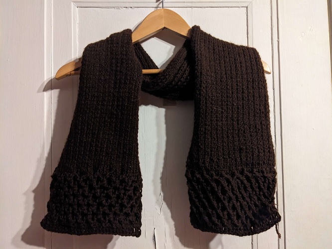 Brown scarf with knit ribbing and diamond cabling at the ends