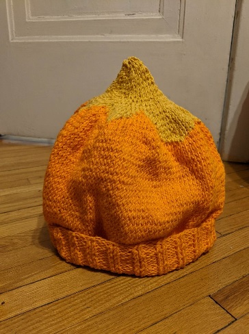 Orange knit hat with yellow star at the top